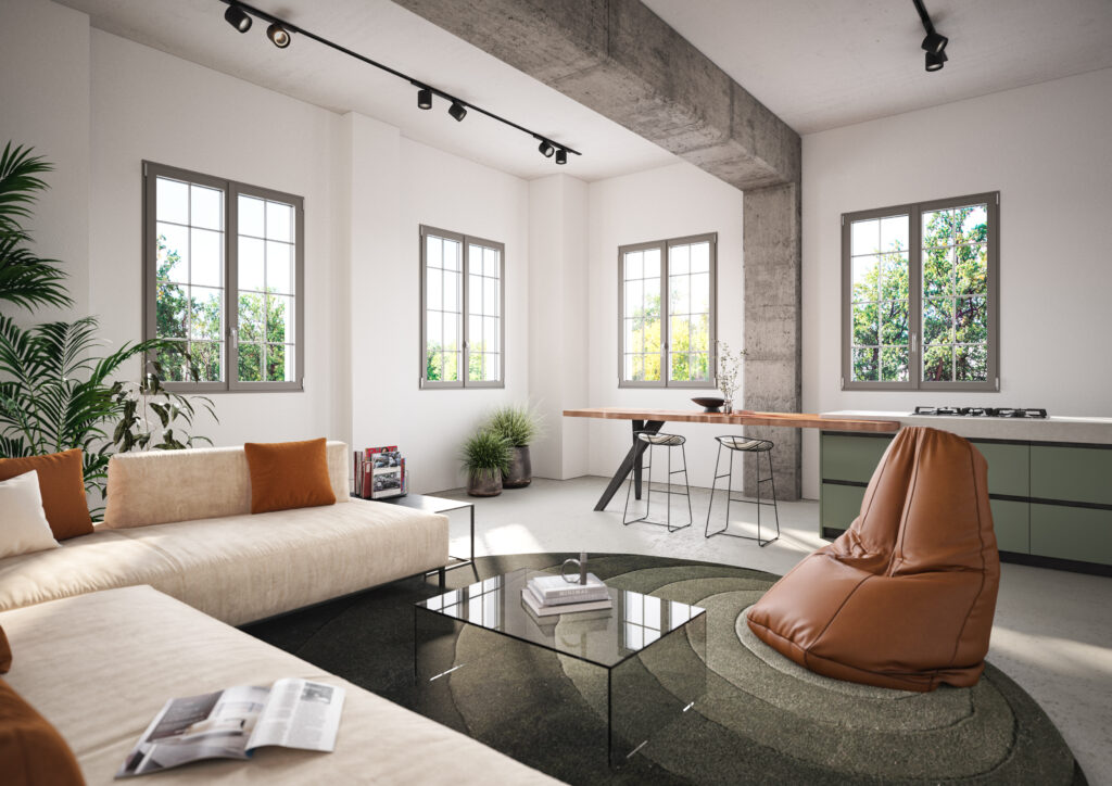 Ampio open space moderno con infissi in alluminio Titano Steel, illuminato da luce naturale e arredato con elementi di design industriale