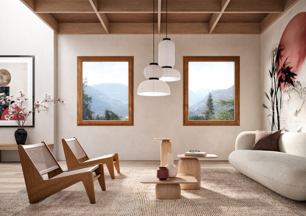 Living dallo stile Japandi con infissi WINERGETIC PREMIUM PASSIVE in Rovere Dorato, vista panoramica sulle montagne e arredi in legno naturale