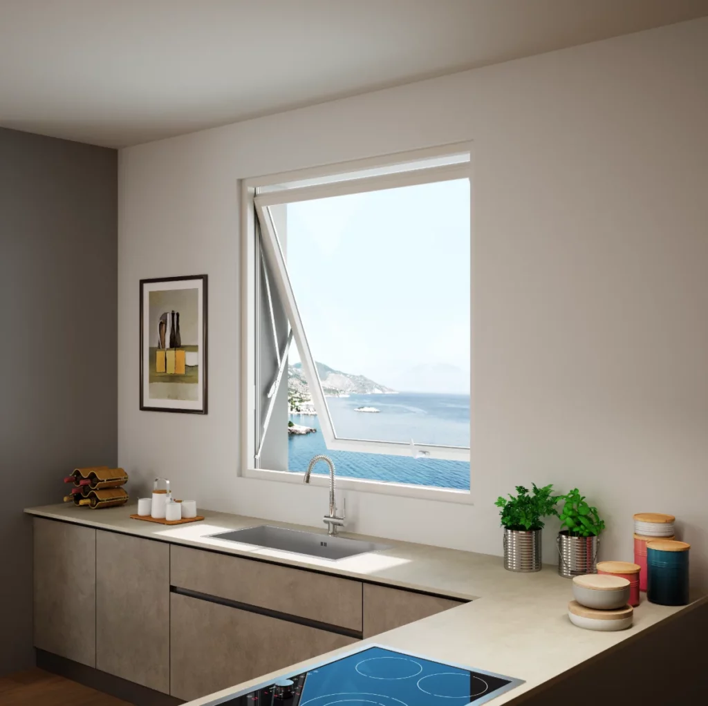 Cucina moderna grigia con piano cottura a induzione, lavello integrato e finestra aperta con vista mare mozzafiato.